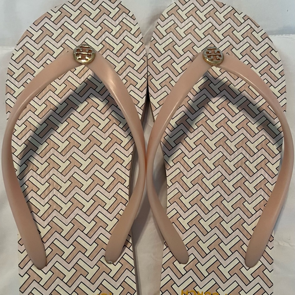 Tory Burch light pink flip flops.
